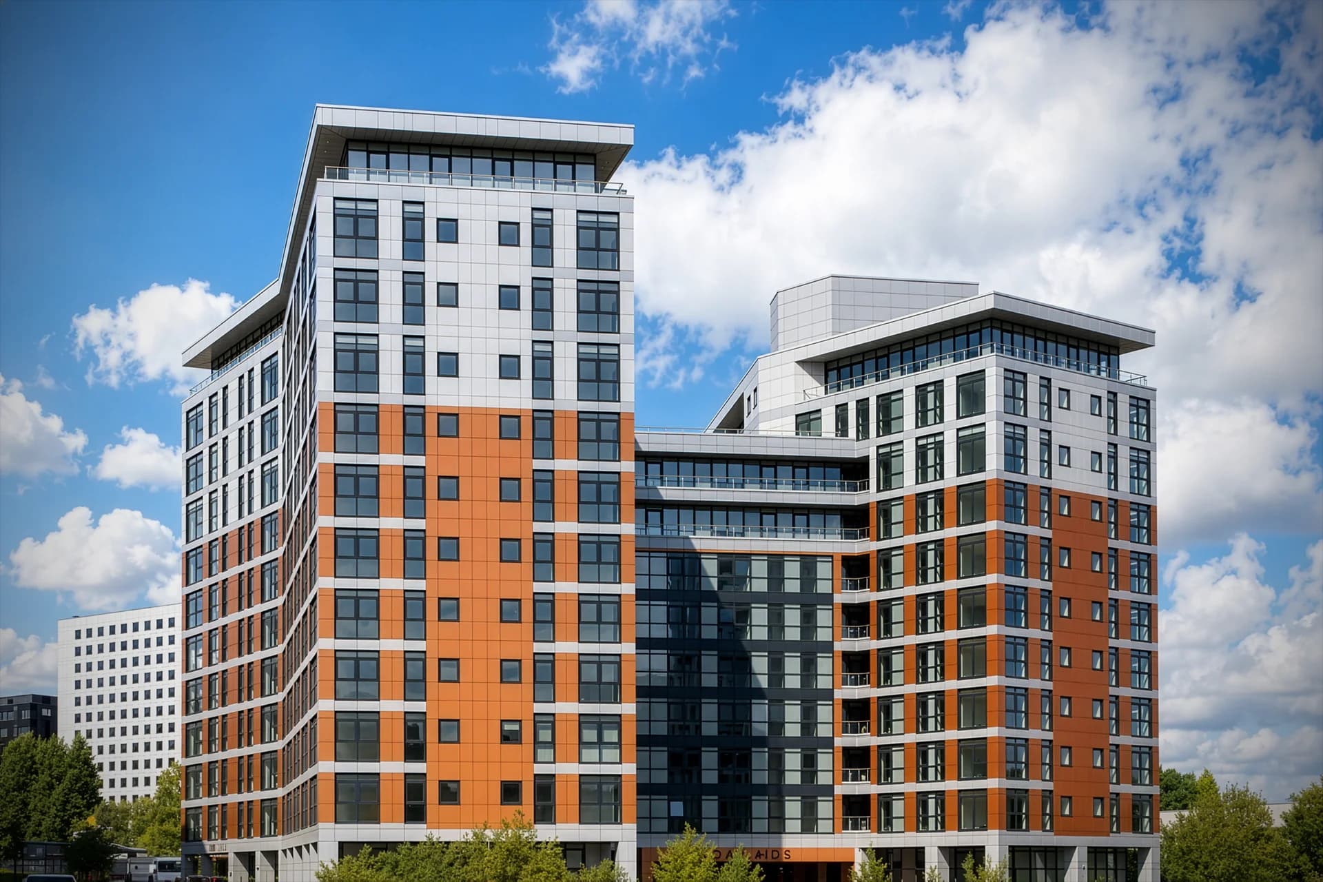 Exterior of the completed Furness Quay apartment towers at Salford Quays, Manchester, showing the white and terracotta cladding