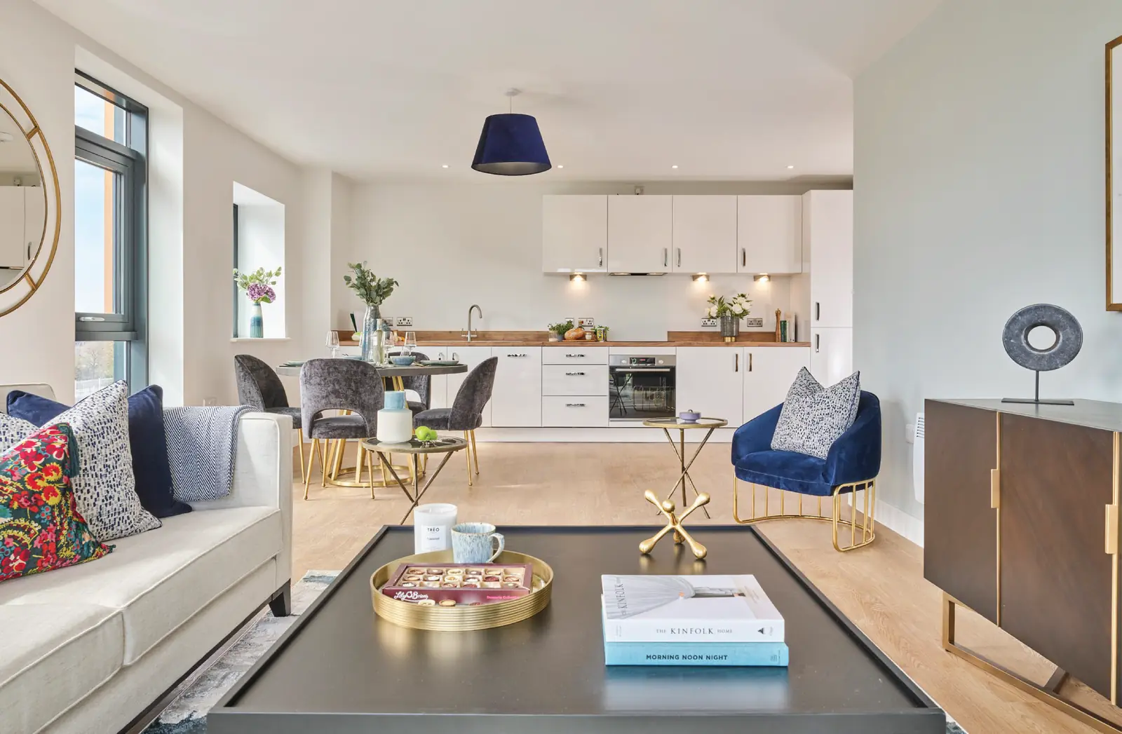 Open plan living, dining and kitchen area in a Furness Quay show apartment with integrated appliances