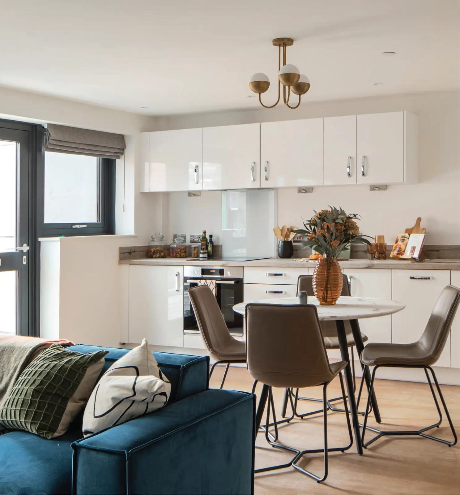 Show apartment living and dining area at Furness Quay with open plan kitchen and contemporary furnishings